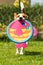 Playful Beagle Dog running with round colorful fish like toy