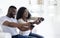 Playful black couple competing with each other in video game