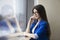 Playful businesswoman in glasses near window