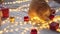 Playful cat with decorative toys. White orange ginger cat is playing with red, gold Christmas balls