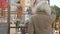 Playful Caucasian boy and girl waving to blurred grandfather standing at front. Portrait of cheerful grandchildren