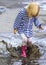 Playful child outdoor jump into puddle in boot