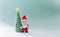 Playful clay christmas concept. Colorful handmade miniature Christmas tree and Santa Claus with mask on green background