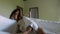 Playful couple in bedroom lying on bed fighting pov young man and woman in morning waking up taking away blanket