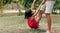 Playful daughter with his father swinging on daddy`s leg outdoors. ï¿½ute little girl playing with her loving dad in the park. Dad