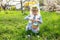 Playful Easter traditions. happy child engages in an egg hunt, filling basket with symbols of spring and renewal.