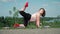 Playful Fat Man with Long Hair Does Gymnastics for Weight Loss Outdoors. Funny Overweight Guy Depicting a Girl Engaged In Fitness