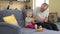 Playful father have fun with baby girl on sofa at home. Man tickle toddler girl