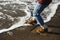 Playful girl touches sea wave boot on the beach