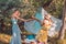 Playful girls fighting with bread baguette making picnic