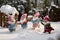 Playful gnomes engaged in a friendly snowball fight in a snowy garden, highlighting the lighthearted and whimsical side of