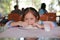 Playful of happy asian little girl kneading homemade pizza dough on table. Process of preparation pizza