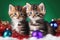 Playful kittens engage with tinsel and festive balls