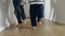 Playful little boys and their mother\'s feet running on wooden floor at home. A heartwarming concept of family love.