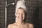 Playful mischievous woman with wet hair in a towel