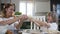 Playful Mum and daughter are making mustache from dough when baking biscuits together in the kitchen at home. Mom with