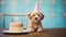 A playful puppy wearing a birthday hat with a cake in front of it