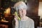 Playful senior woman answering telephone with a banana