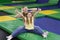 Playful silly mom with her teen daughter sitting at trampoline area of entertainment centre, showing thumbs up gesture