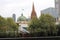 Playful single seagull posing by the river in the CBD inner city Melbourne with city buildings and Flinder`s street station in th