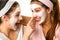 Playful teen wearing mask touches friend\'s nose