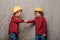 Playful twin boys shaking hands