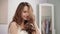 Playful woman touching hair in bathroom. Portrait of sensual woman drying hair