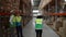 Playful woman warehouse worker riding pallet truck