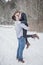 Playful young couple outdoors in winter