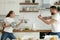 Playful young couple playing with kitchenware in kitchen