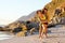 Playful young mixed race couple at the beach