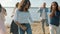 Playful young people friends dancing enjoying crazy beach party laughing on summer day