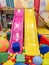 Playground, children`s slides, a play area of colorful plastic balls. Cheerful children`s leisure with balls in the play pool, o