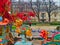 Playground detail and woman with red umbrella, a rainy day in Paris, France