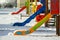 Playground in kindergarten for children in winter with snow cove