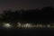 Playground lights breaking through fog at night