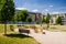 Playground in nature in front of row of newly built block of flats