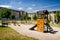 Playground in nature in front of row of newly built block of flats