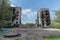 Playground with an residential building bombed by the Russian army on background. Borodyanka, Kyiv oblast, Ukraine.