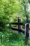 Playhouse on a fence among trees and plants.