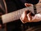 Playing acoustic guitar closeup