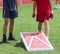 Playing bean bag toss corn hole on turf field