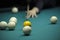 Playing billiard. Player arm gets ready to stroke a ball with a cue