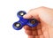 Playing with a blue Fidget Spinner