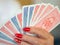 Playing cards with the back lined up in a woman`s hand