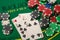 playing cards and casino poker chips on green table