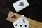 Playing cards and cribbage board on black background