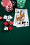 Playing cards, dices and casino chips on poker table