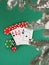 Playing cards and poker chips near a Christmas tree