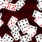 Playing cards scattered on mahogany wooden table - seamless pattern texture background
